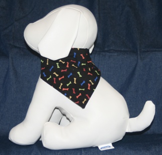 Stuffed Dog Modeling Multi-colored Bones on Black Bandana