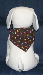 Stuffed Dog Modeling Multi-colored Bones on Chocolate Bandana