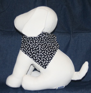 Stuffed dog modeling dog bones on black bandana