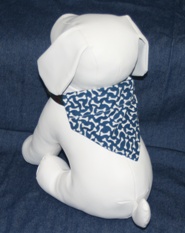 Stuffed dog modeling dog bones on blue bandana